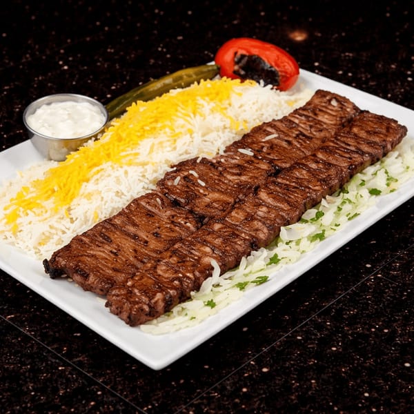 Two long strips of grilled Persian beef kabob, rice, and a side of sauce on a white plate.